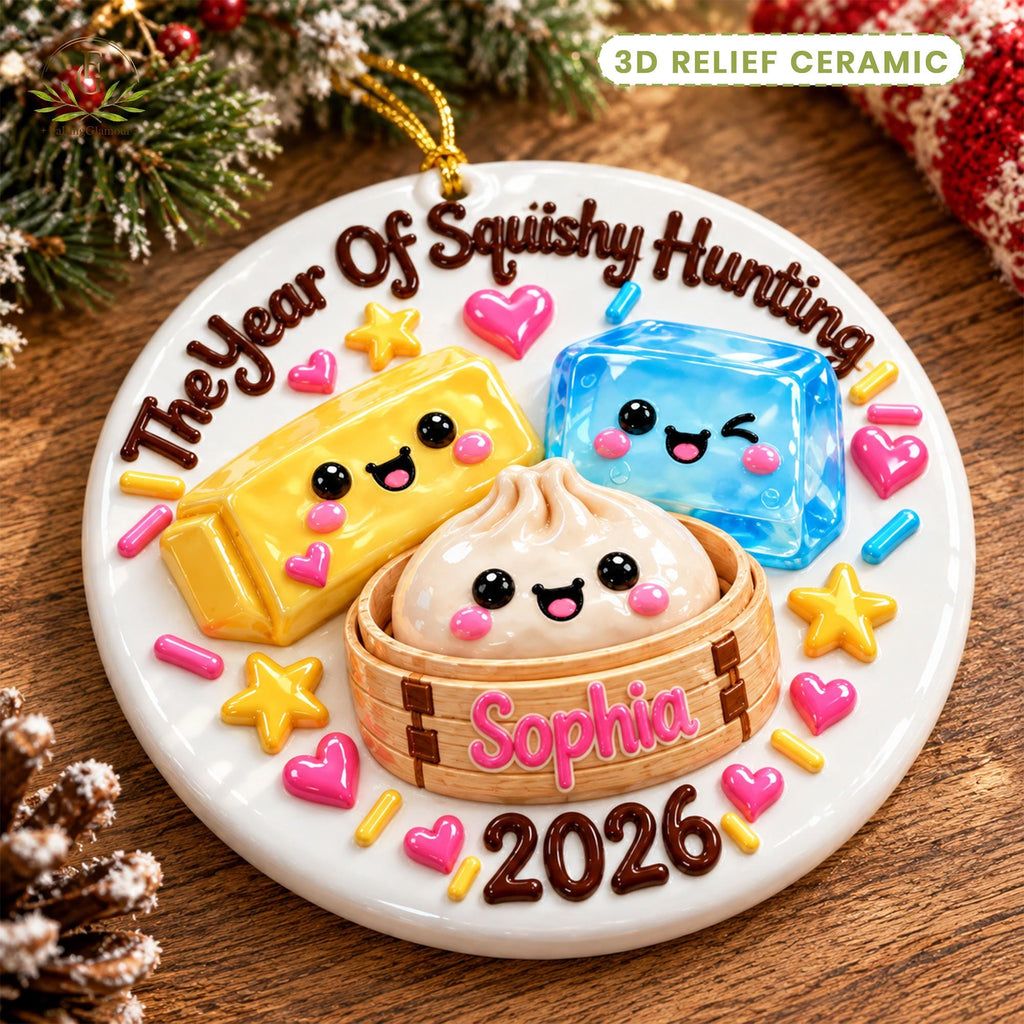 May include: A round white 3D relief ceramic ornament featuring the text The Year Of Squishy Hunting, a yellow block, a blue block, and a dumpling in a bamboo steamer with the name Sophia and the year 2026, decorated with pink hearts and stars.