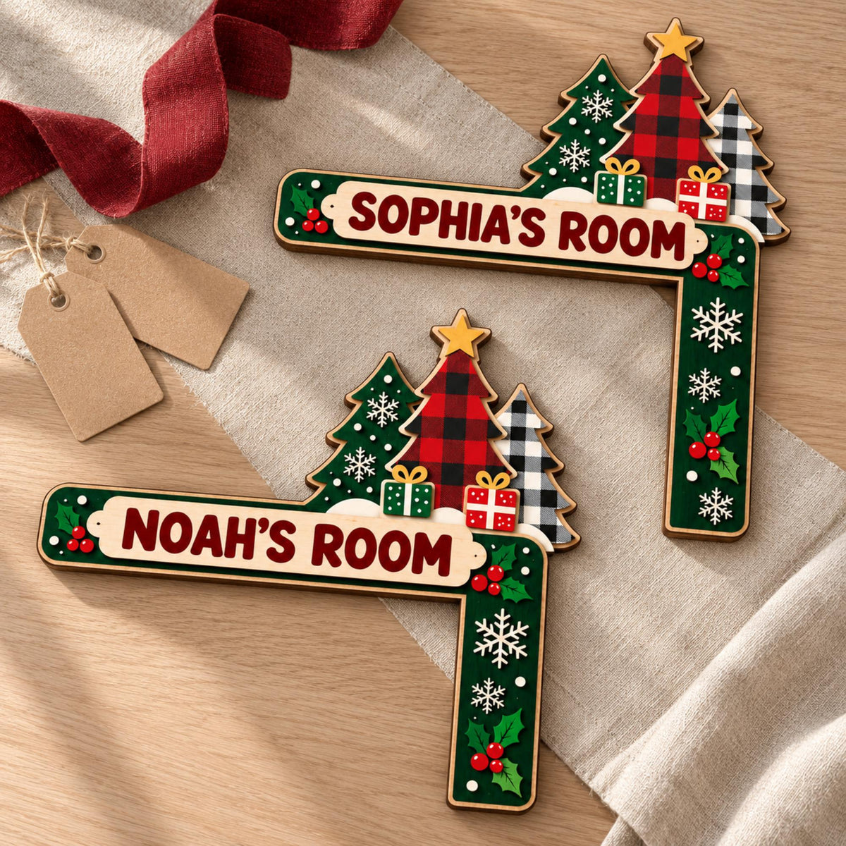 May include: Two L-shaped wooden door corner signs featuring Christmas tree motifs with red and black buffalo plaid, green, and white patterns. Each sign displays the text SOPHIA'S ROOM or NOAH'S ROOM, decorated with snowflakes, holly, and gift boxes.