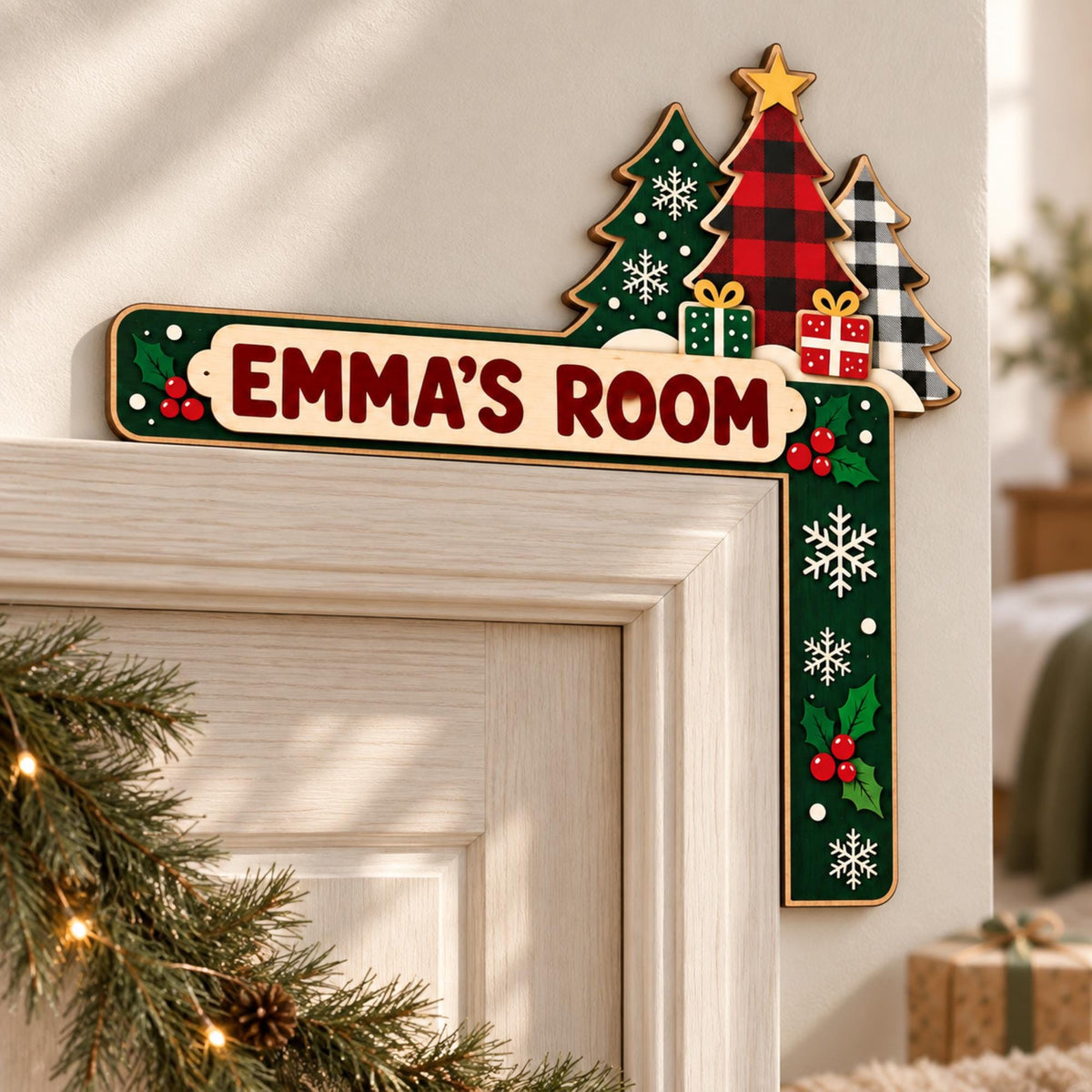 May include: A wooden L-shaped door corner sign featuring the text EMMA'S ROOM in dark red letters. The design includes green and red plaid Christmas trees, small gift boxes, white snowflakes, and red holly berries on a dark green background.