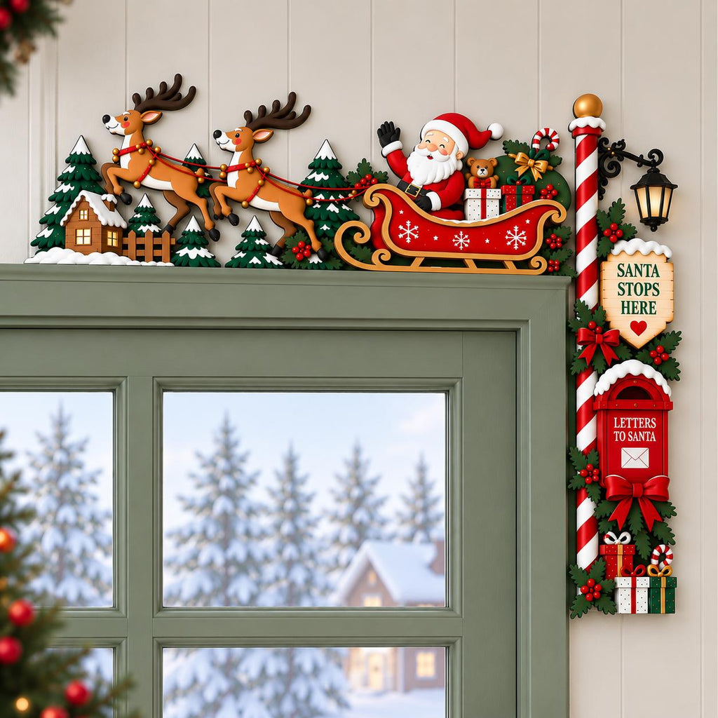 May include: A Christmas door corner decoration featuring Santa Claus in a red sleigh pulled by two reindeer over a snowy landscape with pine trees. A vertical post includes a lantern, a sign reading SANTA STOPS HERE, and a red mailbox for letters.