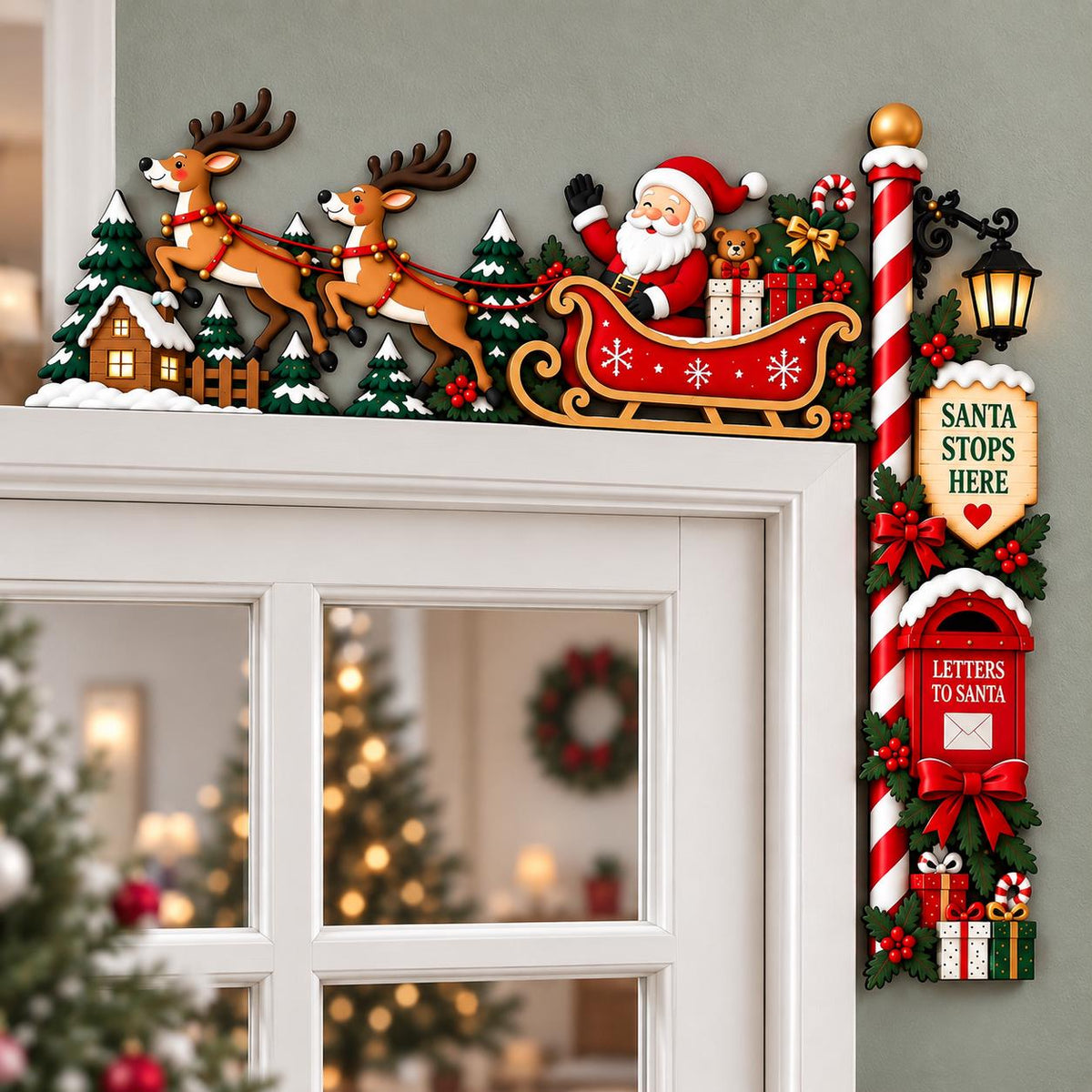 May include: A Christmas door corner decoration featuring Santa Claus in a red sleigh pulled by two reindeer over a snowy landscape with pine trees. A vertical post includes a lantern, a sign reading SANTA STOPS HERE, and a red mailbox for letters.