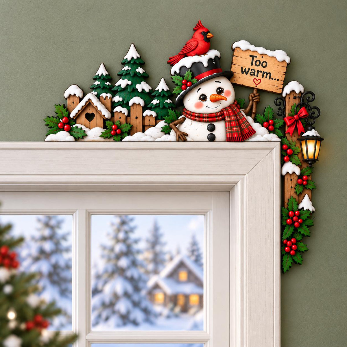 May include: A decorative door topper featuring a snowman wearing a black top hat with a red cardinal on top and a red plaid scarf. The snowman holds a wooden sign that reads Too warm... with a heart. Includes green pine trees and a lantern.