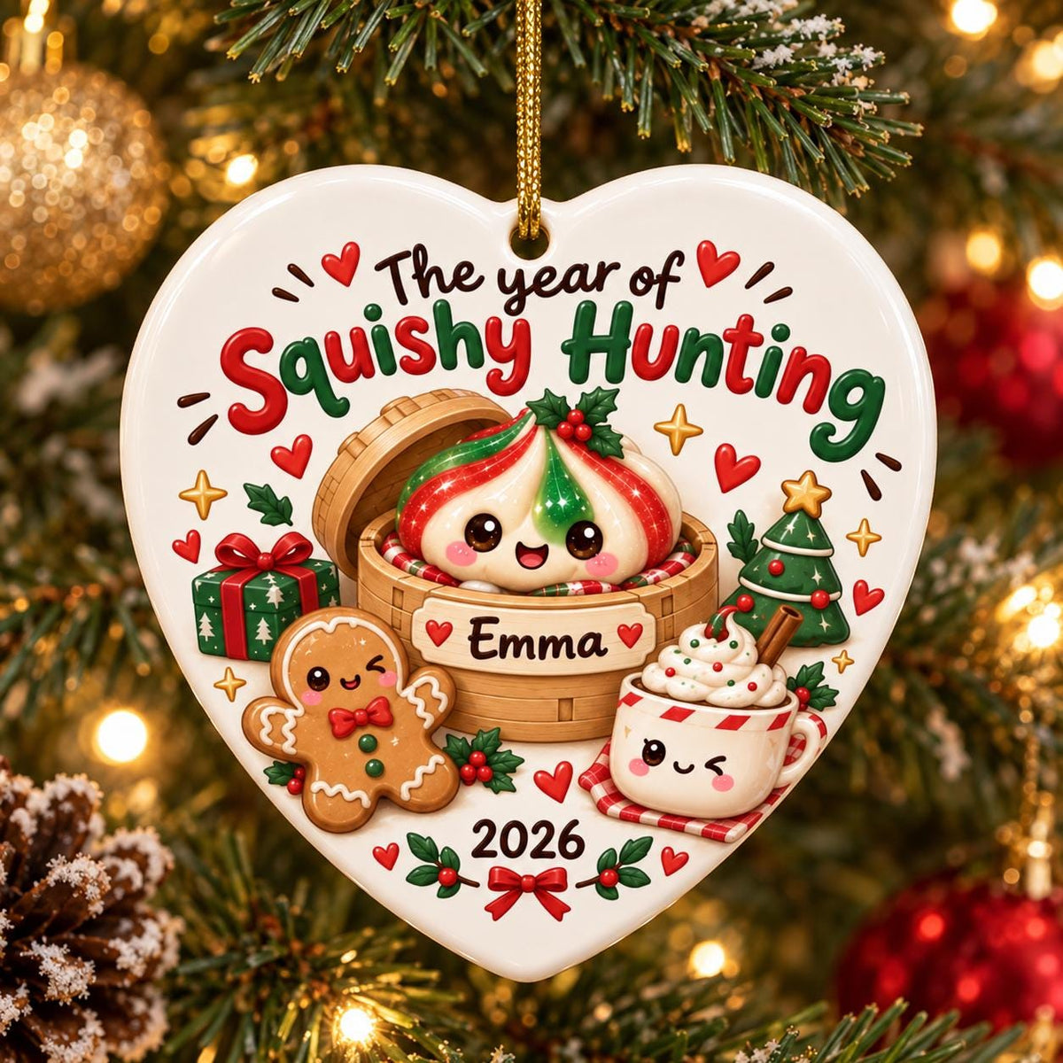May include: A heart-shaped white ceramic Christmas ornament featuring the text The year of Squishy Hunting and Emma. The design includes a cute dumpling in a bamboo steamer, a gingerbread man, a hot cocoa mug, a gift box, and a small tree.