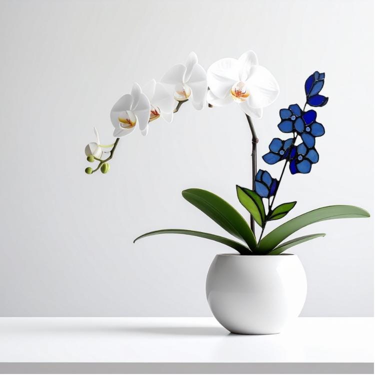 May include: A white ceramic pot holds a vibrant orchid plant with white flowers and green leaves. A decorative blue stained glass flower arrangement adds a pop of color. The arrangement is set against a clean white background.