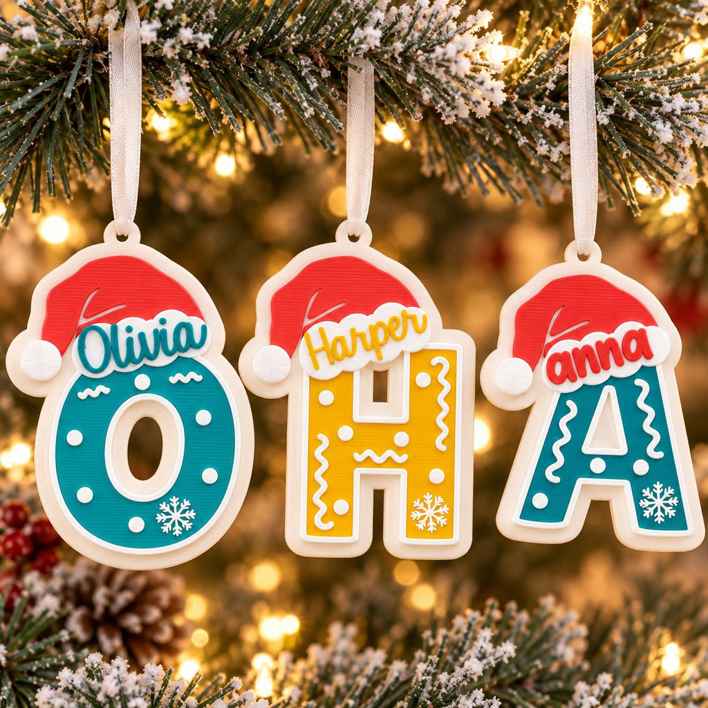 May include: Three hanging ornaments shaped as the letters O, H, and A. Each letter is topped with a red Santa hat and features white ribbon loops. The O is teal with white dots, the H is yellow with white squiggles, and the A is teal with white dots.