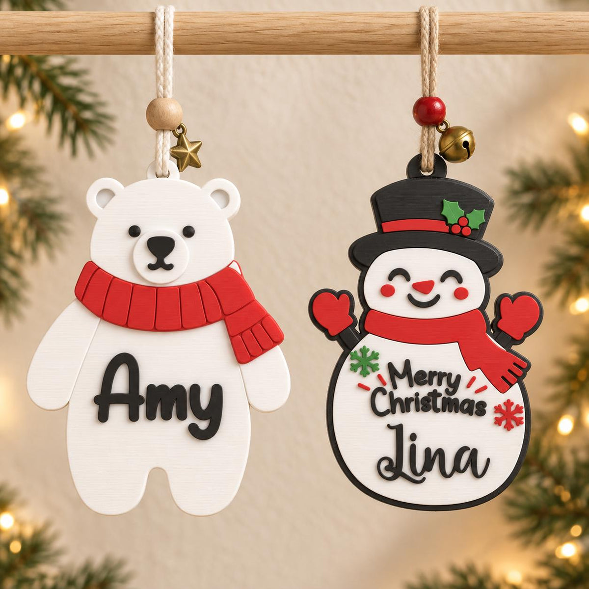 May include: Two hanging ornaments: a white polar bear with a red scarf and the name Amy in black, and a white snowman with a black hat, red scarf, and the name Lina with the text Merry Christmas in black, both featuring small hanging charms.