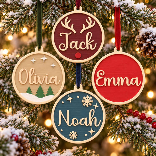 May include: Four circular Christmas ornaments with light-colored frames and velvet ribbons. One is maroon with antlers and the name Jack, one is tan with trees and the name Olivia, one is red with the name Emma, and one is teal with snowflakes and the name Noah.