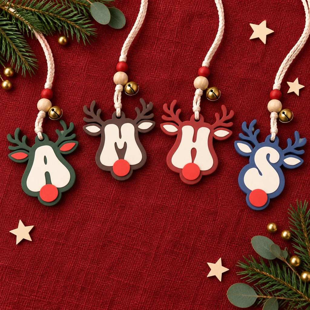 May include: Four reindeer-shaped ornaments featuring the letters A, M, H, and S in white. Each ornament has a red nose, antlers, and a braided cord with red and natural wooden beads and a small gold bell. The reindeer are dark green, brown, red, and blue.