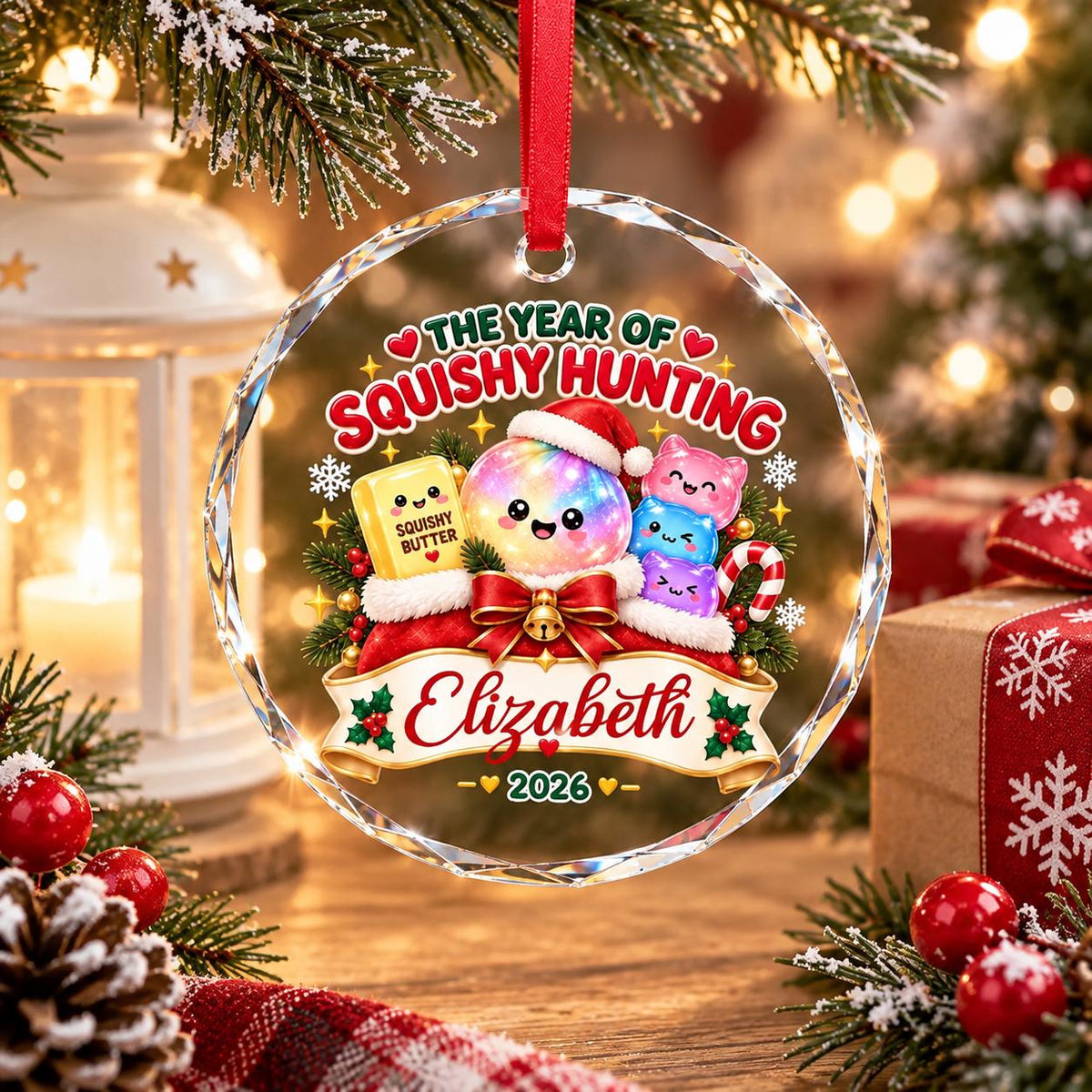 May include: A round, clear acrylic Christmas ornament featuring a colorful graphic of a smiling, iridescent sphere wearing a Santa hat, surrounded by small squishy toys, a butter block labeled Squishy Butter, and the text The Year of Squishy Hunting.