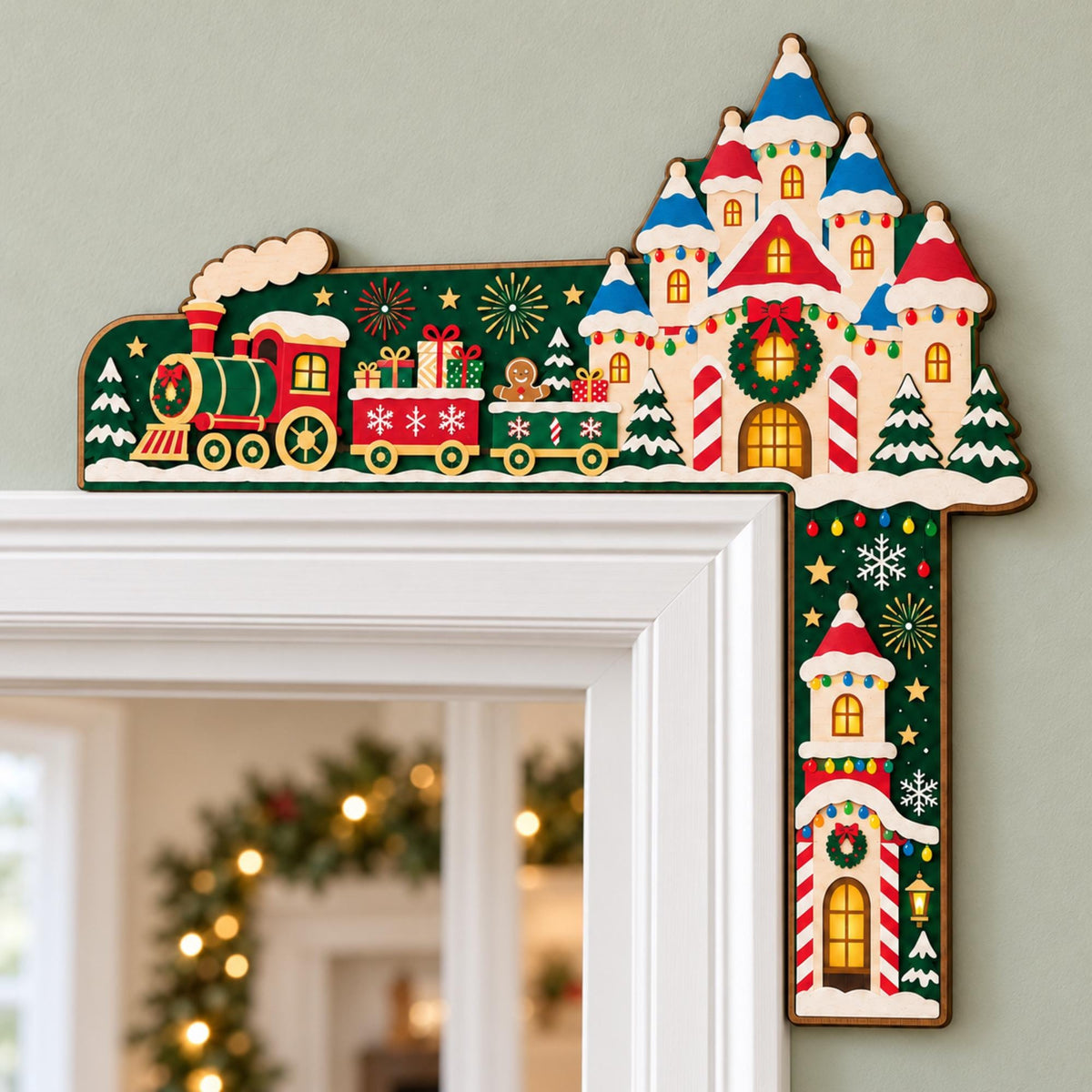 May include: A decorative wooden door corner topper featuring a festive Christmas scene with a red and green steam train pulling cars filled with gifts, a gingerbread person, and a castle with blue roofs, all set against a dark green background.