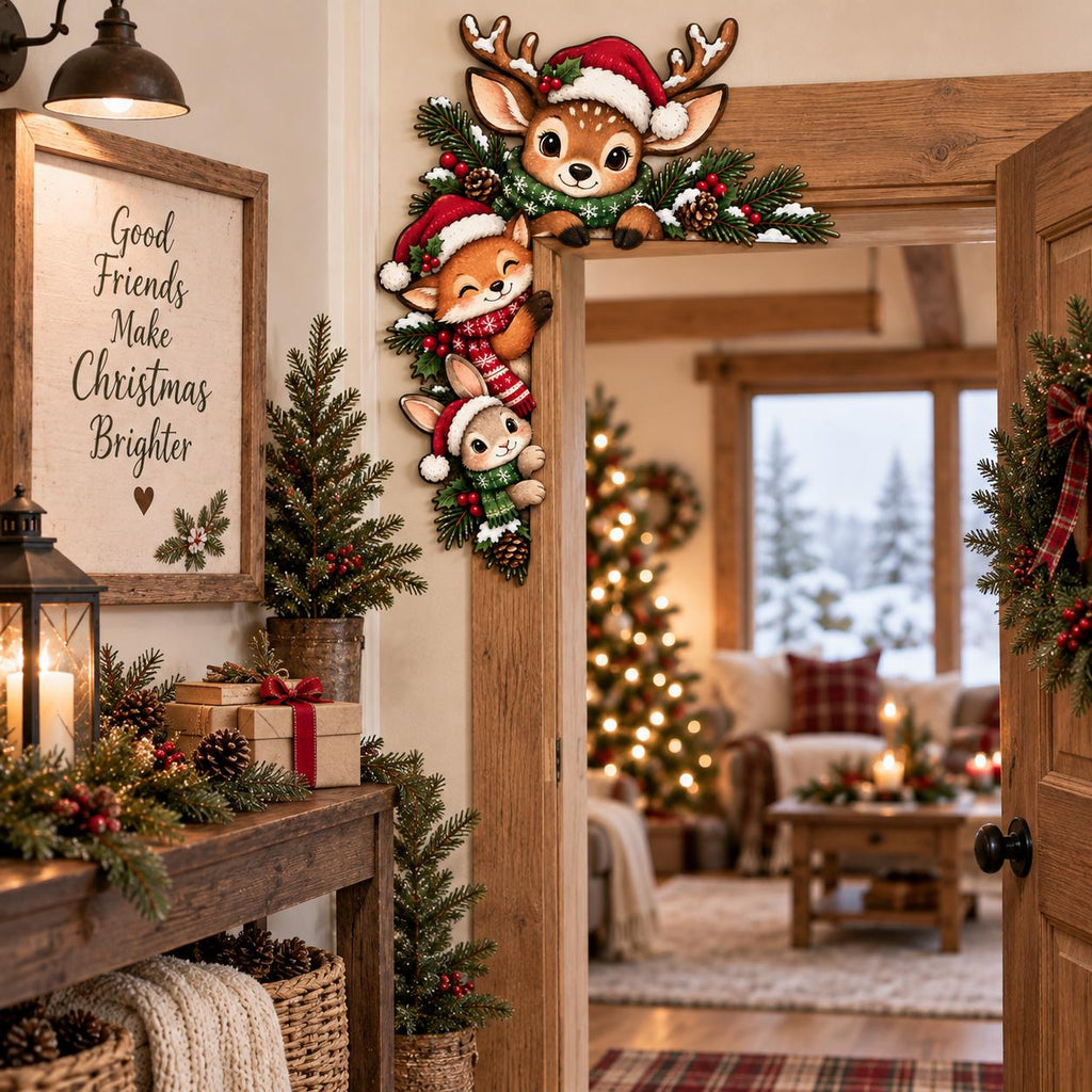 May include: A decorative wooden door corner sign featuring a cartoon deer, fox, and rabbit wearing Santa hats and scarves, nestled among pine branches and pinecones. The sign is positioned on the upper right corner of a wooden door frame.